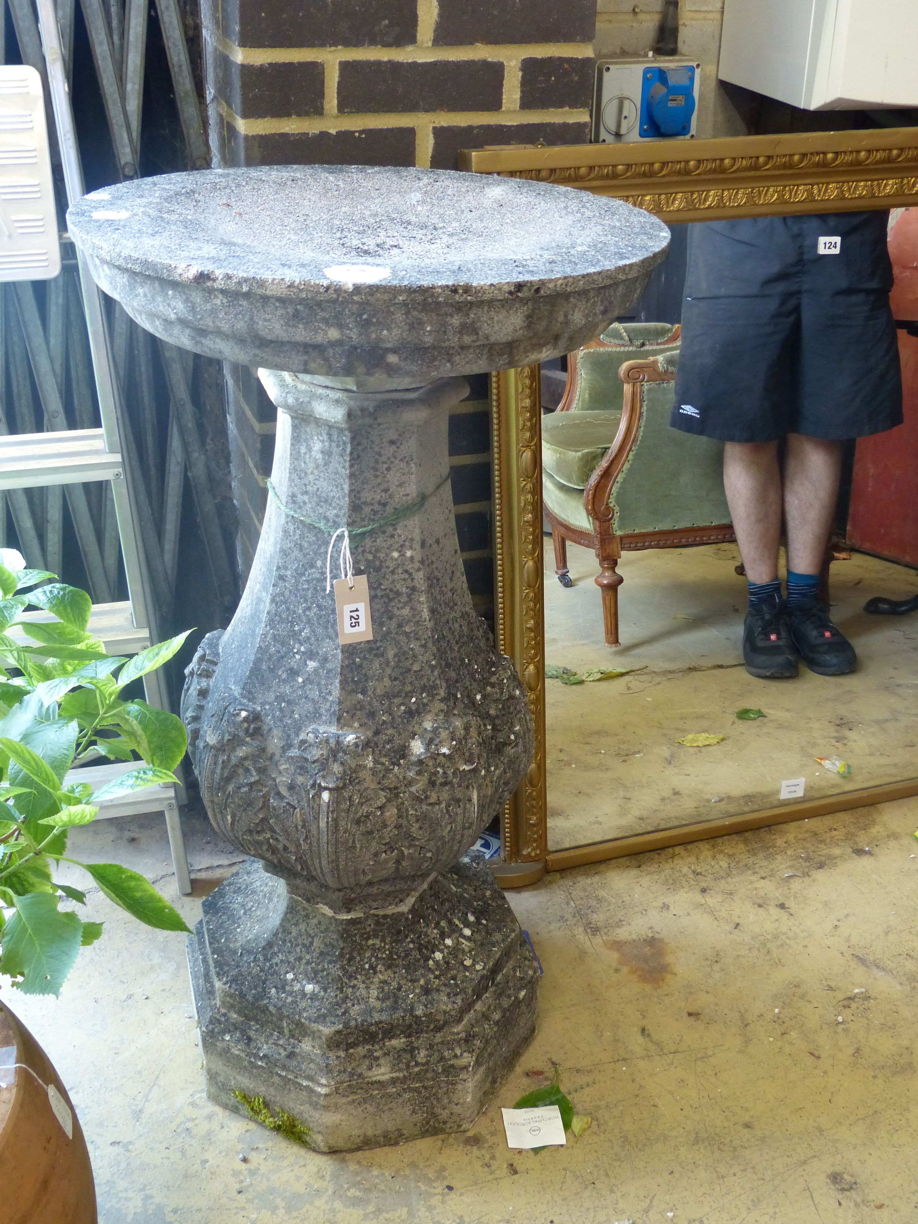 A reconstituted stone bird bath